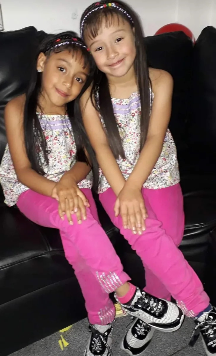 Mafe y Sofi sentadas, vestidas igual